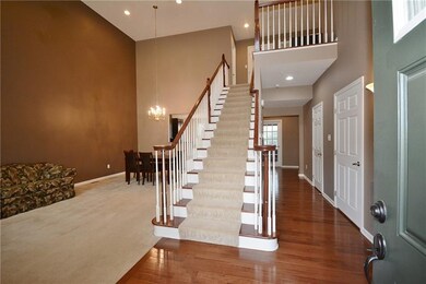 Warm and welcoming foyer with grand staircase