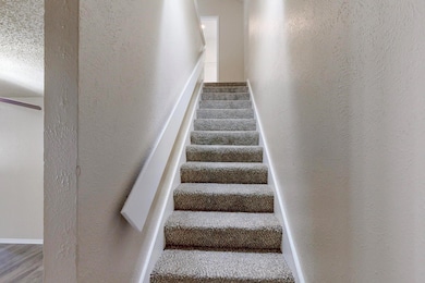 Stairway featuring wood finished floors and a text