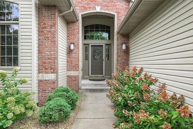 This custom built home features a timeless brick front, architectural details, covered front porch, gutters, new exterior light fixtures and a brand new roof (2025)!