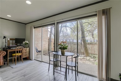 Dining area with ornamental molding, wood finishe
