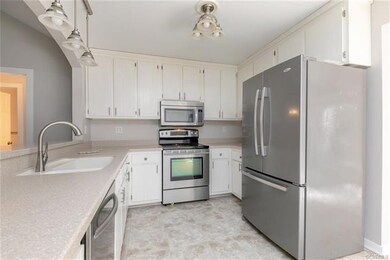Kitchen w/ SS appliances and solid surface counter
