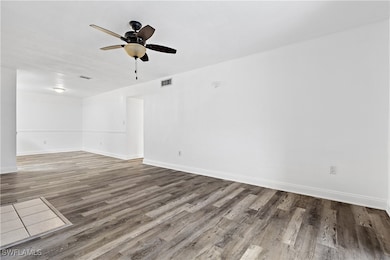 Unfurnished room featuring hardwood / wood-style f