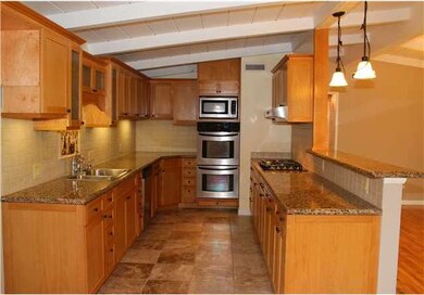Kitchen is upgraded with granite slab counter tops
