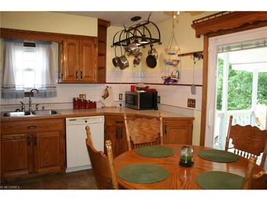 Oak kitchen with tile backsplash. Patio door has i