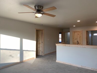 Spare room with a sink, baseboards, recessed light