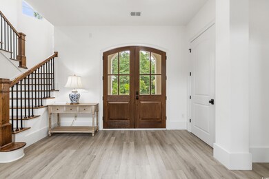 Entryway with french doors and light hardwood / wo