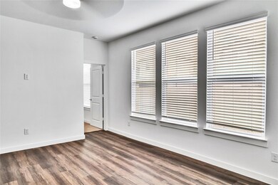 Unfurnished room featuring ceiling fan, wood finis