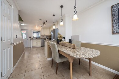 Dining area featuring crown molding, light tile pa