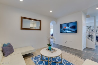 Living area featuring arched walkways, recessed li