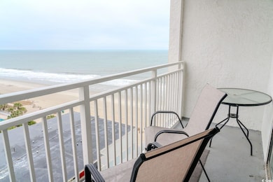 Balcony with a water view and a view of the beach