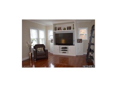 Light filled living room with refinished wood floo
