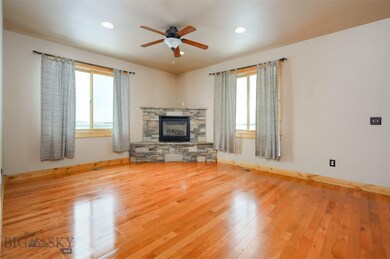 Cozy fireplace in living area with hardwood floors