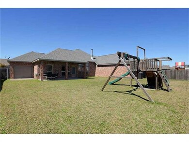 Exterior Back. Covered patio, fenced yard & garage