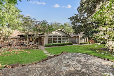 View of the house from the stone patio in back - note the wall of high quality vinyl windows that were added throughout the home in 2015