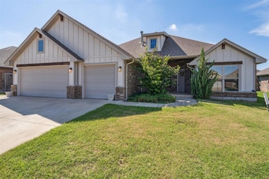 View of front of property with brick siding, roof with shingles, board and batten siding, and concrete driveway