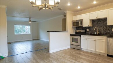 Kitchen is open to living area and both have wood 