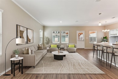 Living room featuring ornamental molding, baseboa