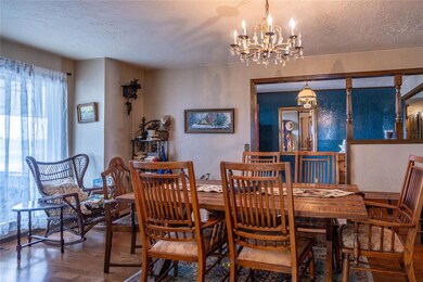 Dining area with a chandelier, a textured ceiling,