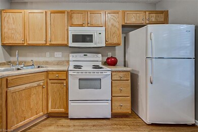 Kitchen with plenty of cabinets and refrigerator included.