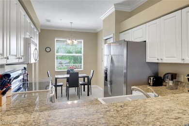 Kitchen featuring white appliances, a sink, crown