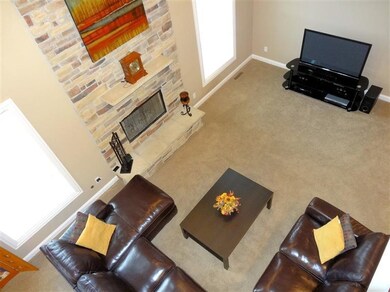 2 story living room and stone fireplace