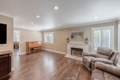 Living Room & fireplace, passage to family room on left