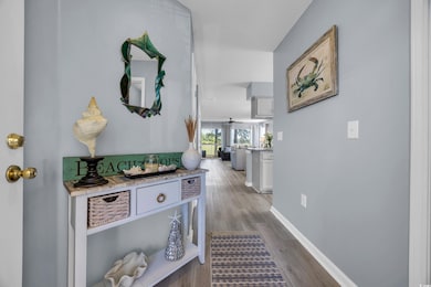 Corridor with wood finished floors and baseboards