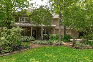 Gorgeous treed front yard has several flowerbeds a