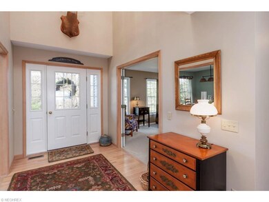 Light and warm front foyer with den/study to the l
