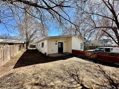 Rear view of property featuring a fenced backyard