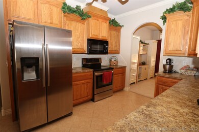 Open kitchen with arched opening to dining room