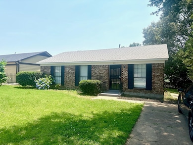 Single story home with a front yard and brick siding