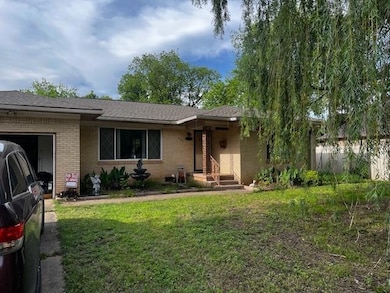 Single story home with brick siding, a front yard,