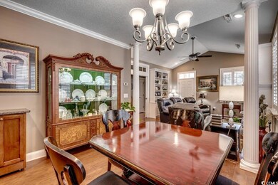 Dining space featuring ornate columns, vaulted cei
