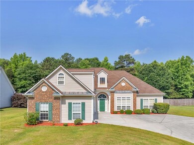 Traditional home featuring brick siding and driveway