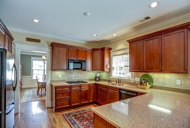 Spacious kitchen has gorgeous cherry cabinets with