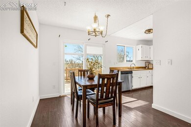 Dining space featuring dark wood-style floors, a c