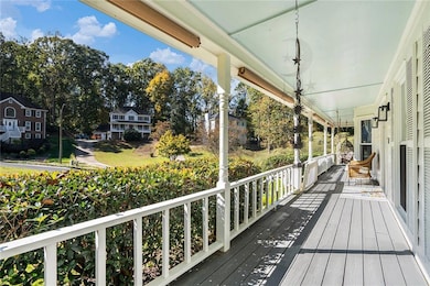 Wooden porch with view of wooded area