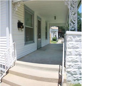 Relax on the shaded covered concrete front porch. 