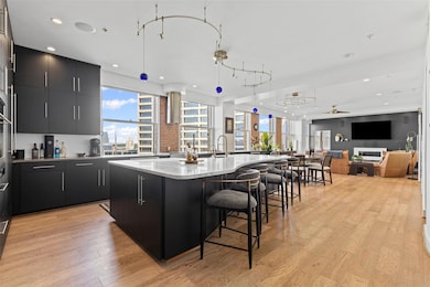 Kitchen with ceiling fan, a spacious island, a bre