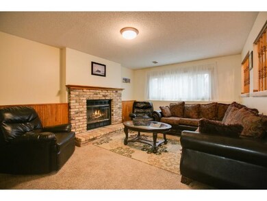 Lower level family room with wood burning fire pla