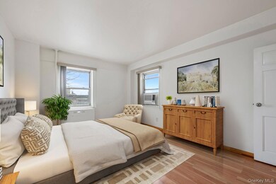 Bedroom featuring multiple windows and light wood finished floors