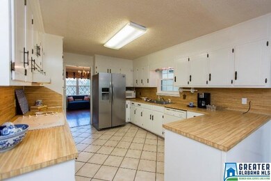 Spacious kitchen with a stainless 3-yr-old refrige