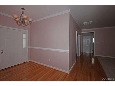 The open foyer has beautiful hardwood floors with 