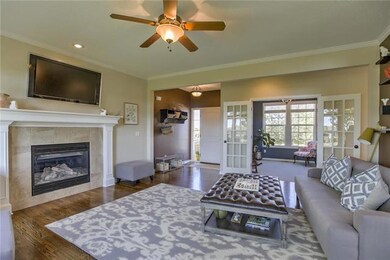 Spacious great room with gleaming hardwoods and fi