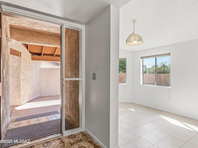 Foyer looking back to entrance and through to the east-in kitchen to the right