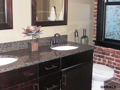 The master bath has ceramic floor and a double-sink vanity with granite top.  The xlarge ceramic shower has a frameless glass door.