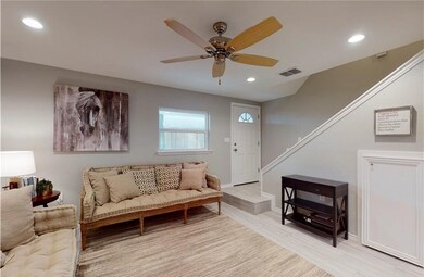 Living room featuring stairs, recessed lighting, v