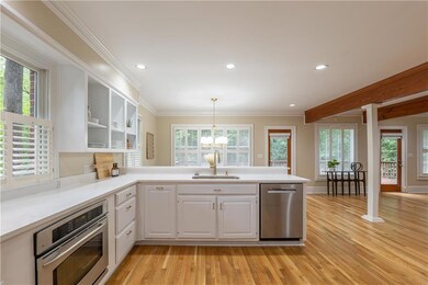 The gourmet kitchen showcases stainless steel appliances—including a five-burner gas range.