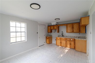 Kitchen with sink and light tile flooring
